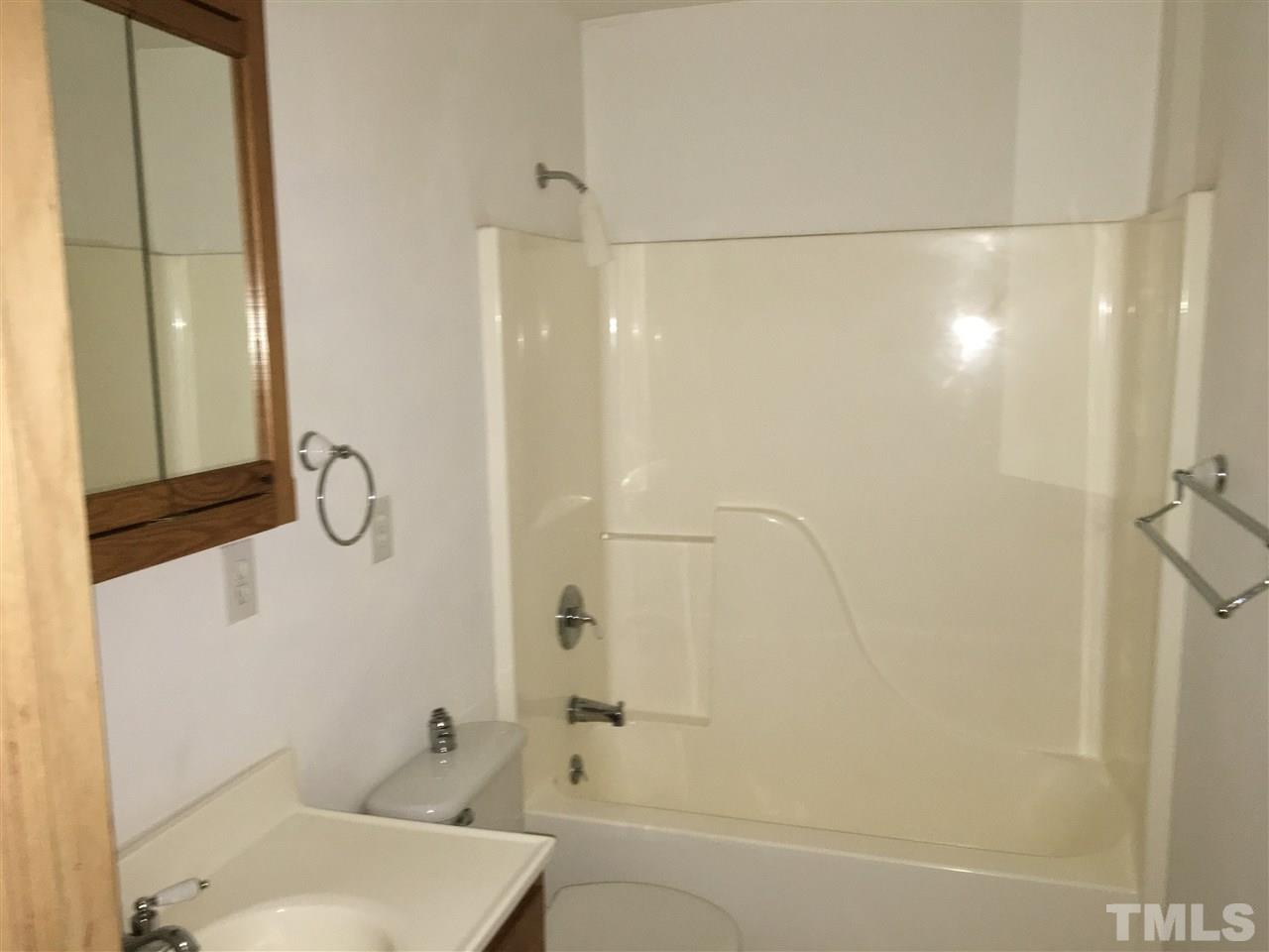 9516 Virgilina Road Roxboro, NC 27574 - Photo 13 of 21 a bathroom with a shower and a toilet