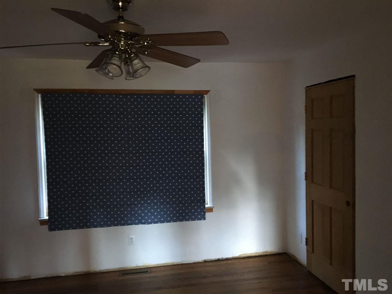 9516 Virgilina Road Roxboro, NC 27574 - Photo 15 of 21 an empty room with wooden floor