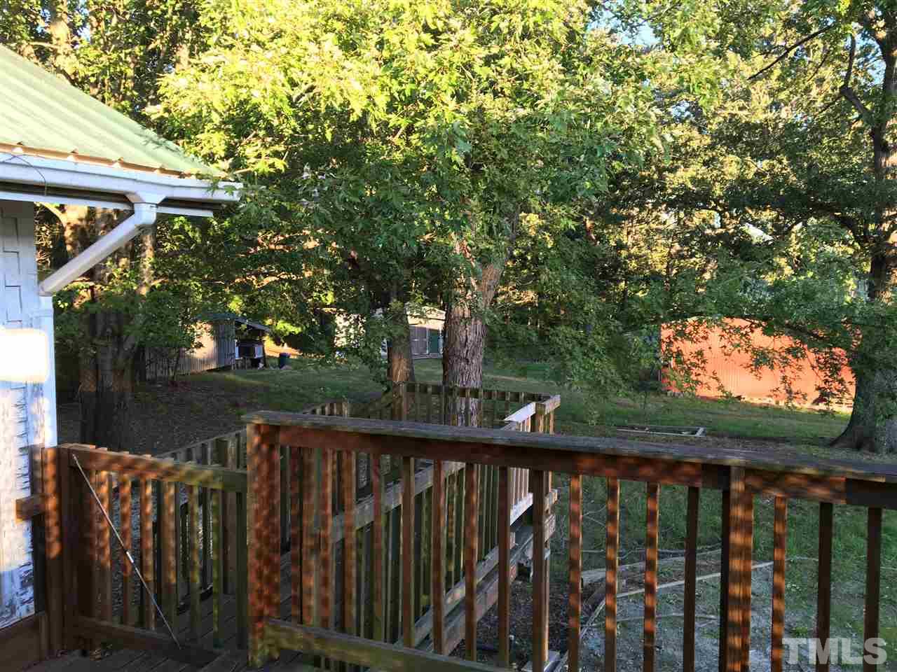9516 Virgilina Road Roxboro, NC 27574 - Photo 21 of 21 a view of a wooden deck next to a yard