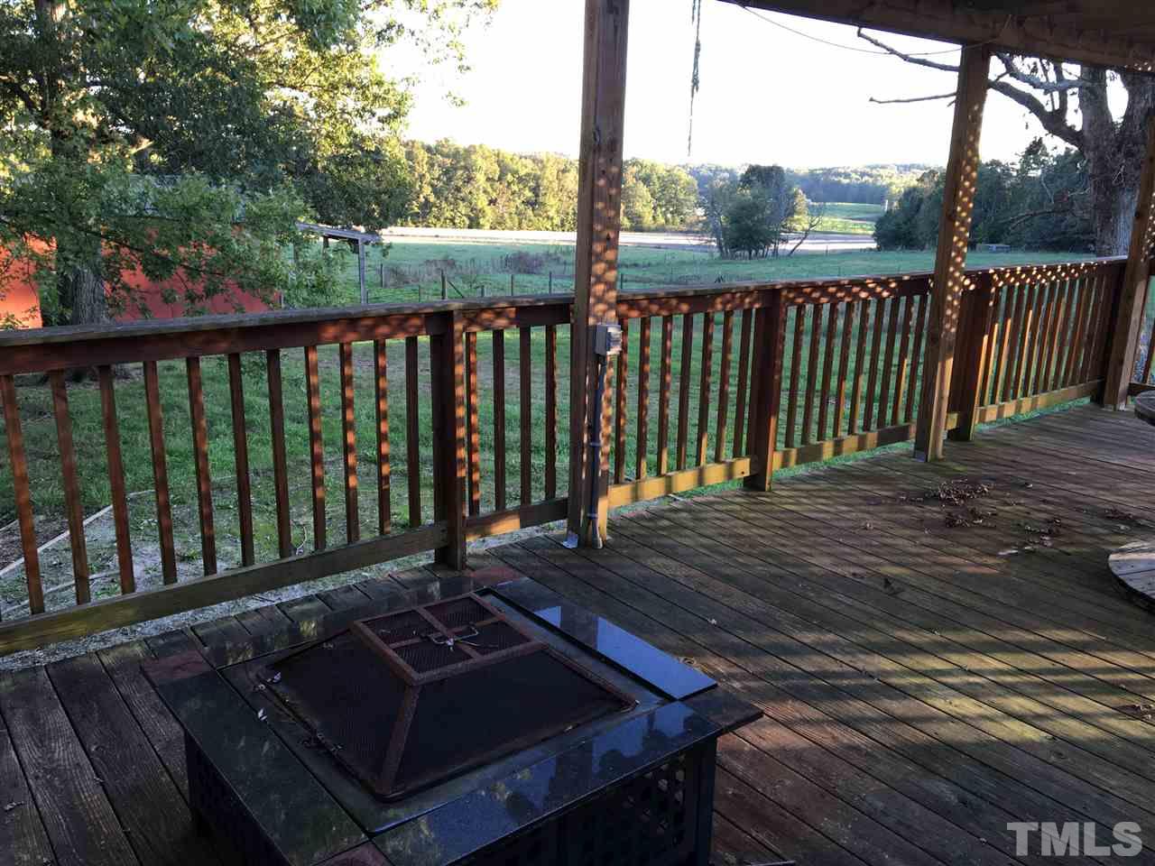 9516 Virgilina Road Roxboro, NC 27574 - Photo 10 of 21 a view of a wooden deck with a bench