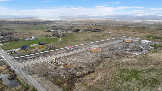 1418 West 2350th South, Unit 15 Perry, UT 84302 - Photo 21 of 22 Aerial perspective showcasing a developing residential area with new road infrastructure and several properties under construction