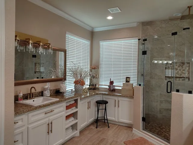 a bathroom with double sink and a mirror