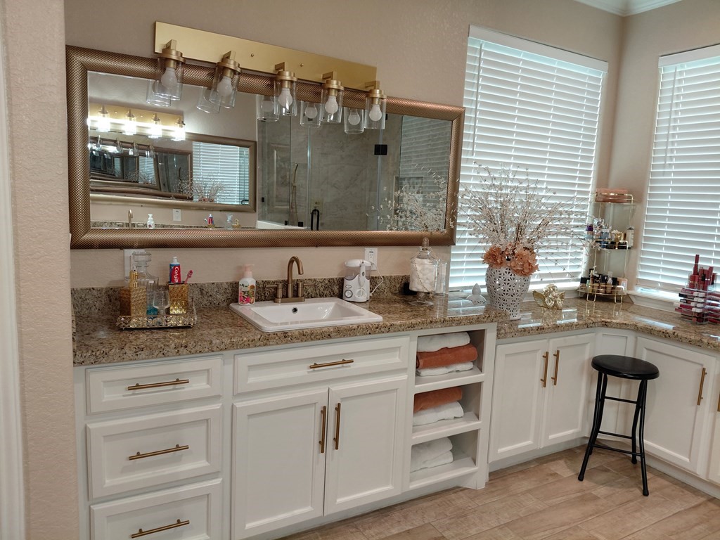 309 Hickman Lane Angleton, TX 77515 - Photo 12 of 33 a bathroom with a granite countertop sink and a mirror