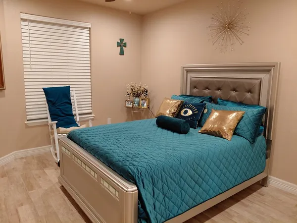 a bedroom with a bed and a window