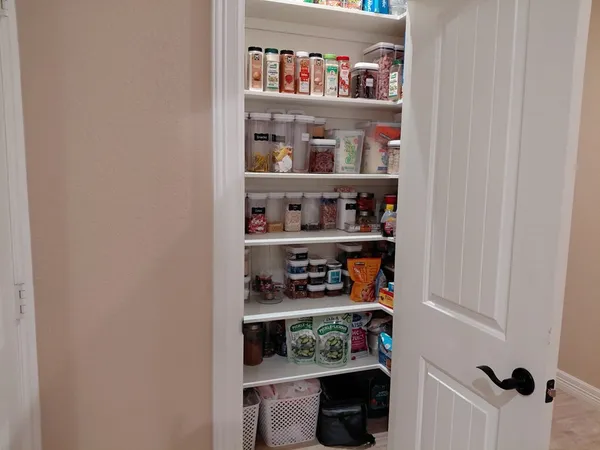 a shelf with cup and plates