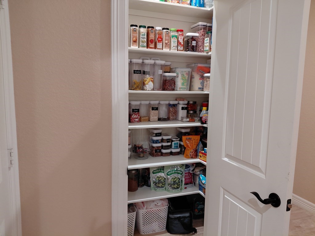 309 Hickman Lane Angleton, TX 77515 - Photo 19 of 33 a shelf with cup and plates