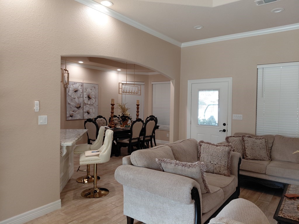 309 Hickman Lane Angleton, TX 77515 - Photo 26 of 33 a living room with furniture a mirror and gym equipment