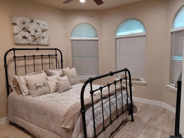 a bedroom with two beds and a window