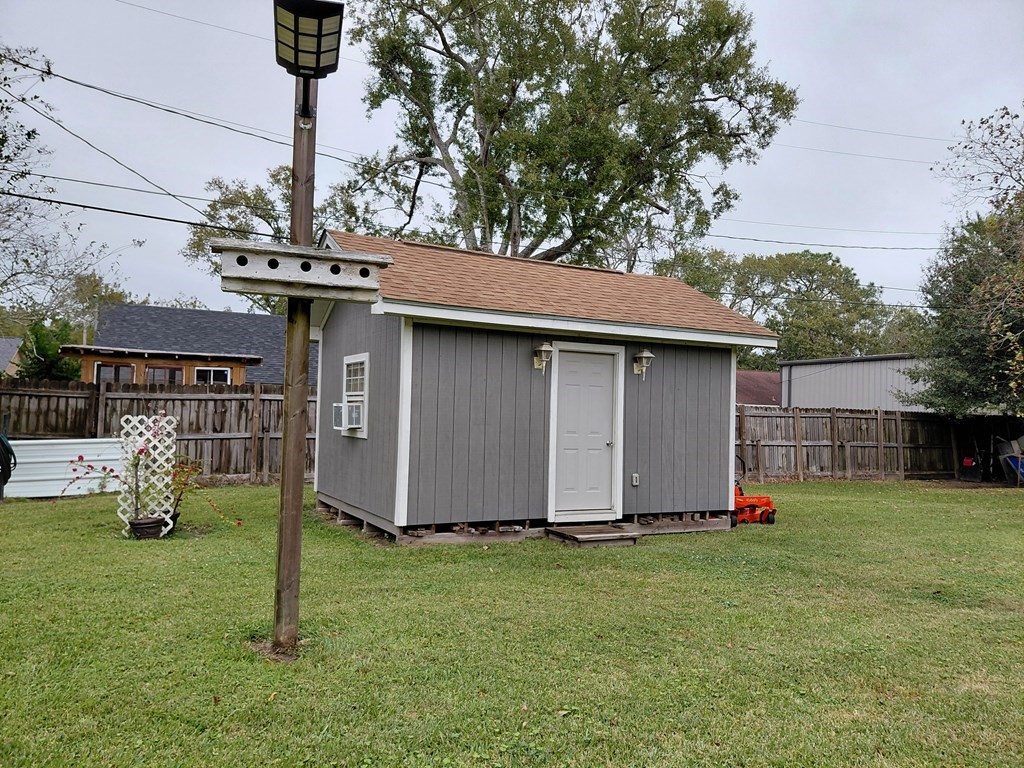 309 Hickman Lane Angleton, TX 77515 - Photo 32 of 33 a view of a backyard with a barn