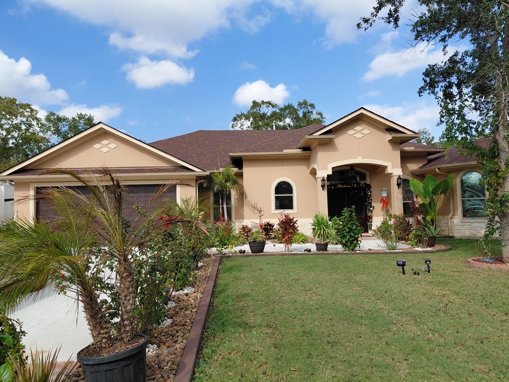 309 Hickman Lane Angleton, TX 77515 - Photo 8 of 33 a view of a white house with a big yard and potted plants