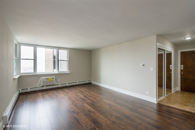 6325 North Sheridan Road, Unit 1005 Chicago, IL 60660 - Photo 13 of 24 an empty room with wooden floor and windows