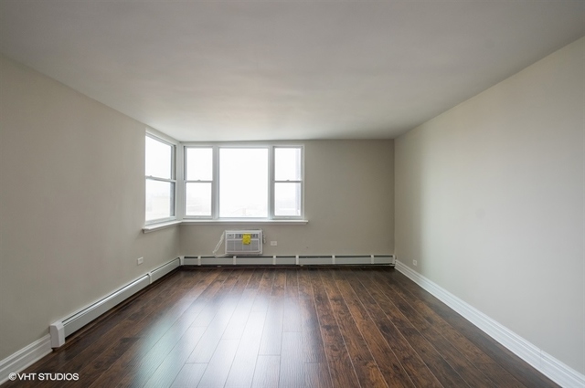 6325 North Sheridan Road, Unit 1005 Chicago, IL 60660 - Photo 17 of 24 an empty room with wooden floor and windows