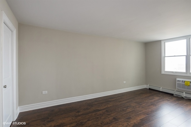 6325 North Sheridan Road, Unit 1005 Chicago, IL 60660 - Photo 18 of 24 an empty room with wooden floor and windows