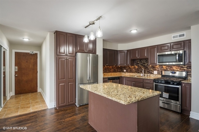 6325 North Sheridan Road, Unit 1005 Chicago, IL 60660 - Photo 3 of 24 a kitchen with stainless steel appliances kitchen island granite countertop a refrigerator and a stove top oven