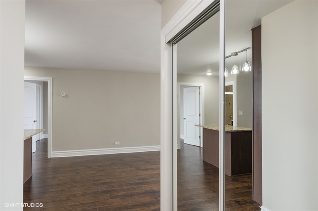 6325 North Sheridan Road, Unit 1005 Chicago, IL 60660 - Photo 22 of 24 a view of an empty room with wooden floor and a bathroom
