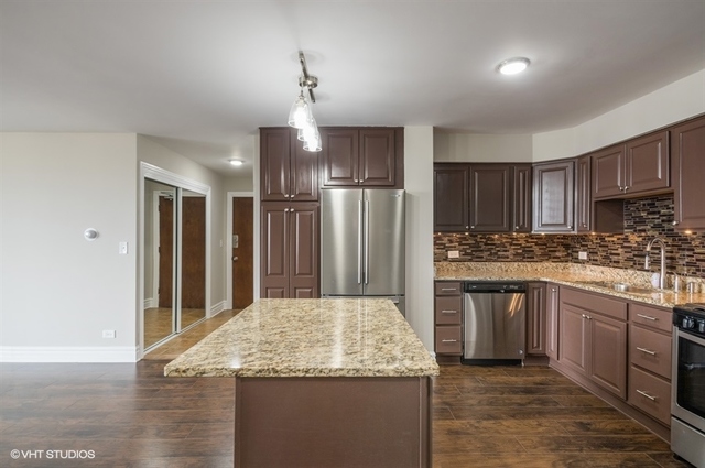 6325 North Sheridan Road, Unit 1005 Chicago, IL 60660 - Photo 4 of 24 a kitchen with kitchen island granite countertop a sink cabinets and stainless steel appliances