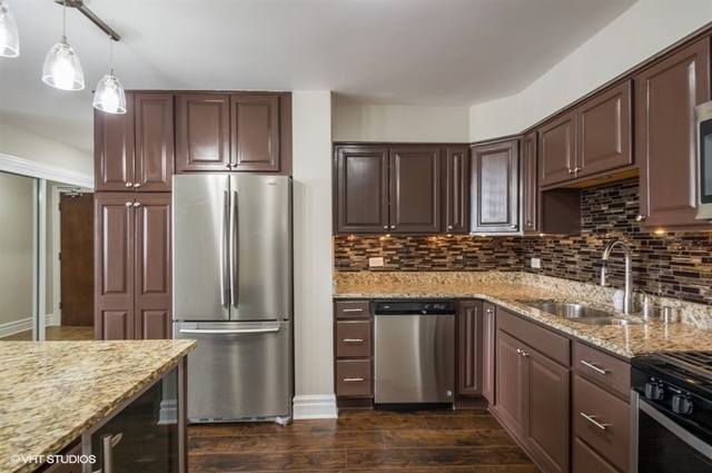 6325 North Sheridan Road, Unit 1005 Chicago, IL 60660 - Photo 5 of 24 a kitchen with stainless steel appliances granite countertop a refrigerator a sink and wooden cabinets