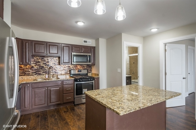 6325 North Sheridan Road, Unit 1005 Chicago, IL 60660 - Photo 7 of 24 a kitchen with stainless steel appliances granite countertop a sink stove and refrigerator
