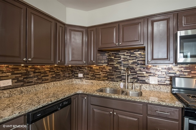 6325 North Sheridan Road, Unit 1005 Chicago, IL 60660 - Photo 8 of 24 a kitchen with granite countertop stainless steel appliances a sink stove and cabinets