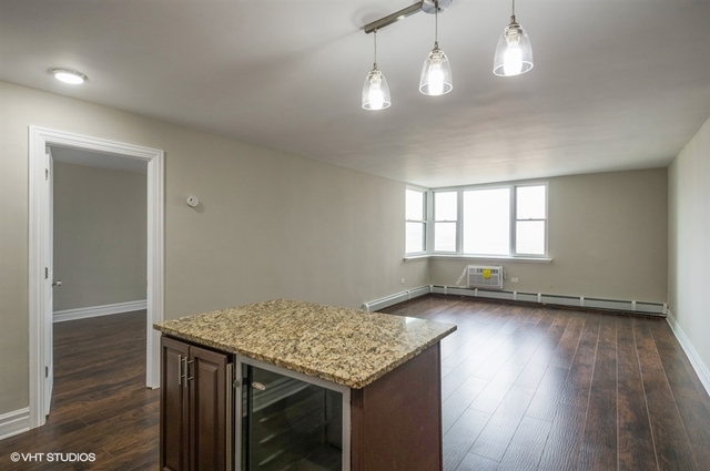 6325 North Sheridan Road, Unit 1005 Chicago, IL 60660 - Photo 10 of 24 an empty room with wooden floor and windows