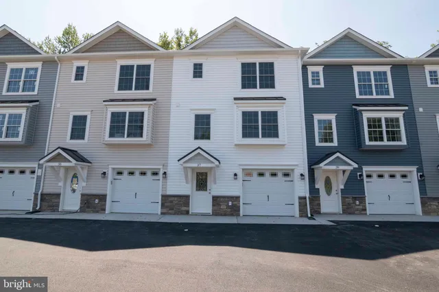 a view of a white building with large windows