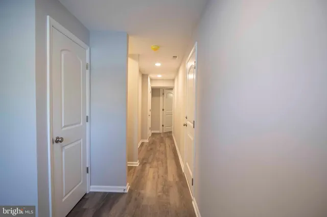 a view of a hallway with wooden floor