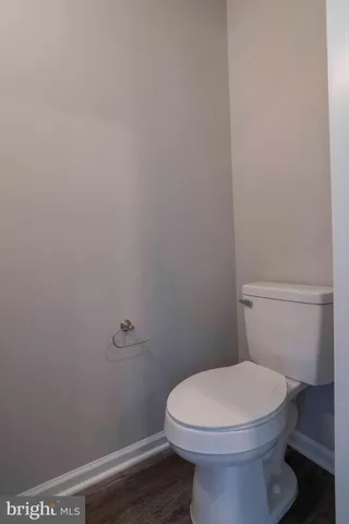 a white toilet sitting next to a shower