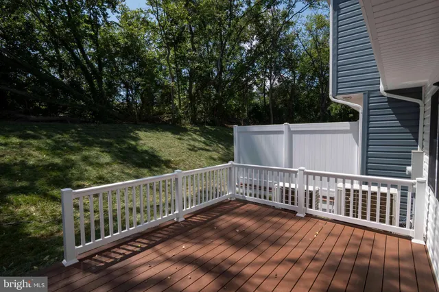 a view of balcony with wooden floor and fence