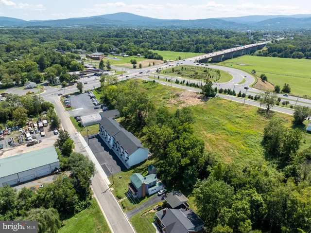 an aerial view of residential houses with outdoor space and city view