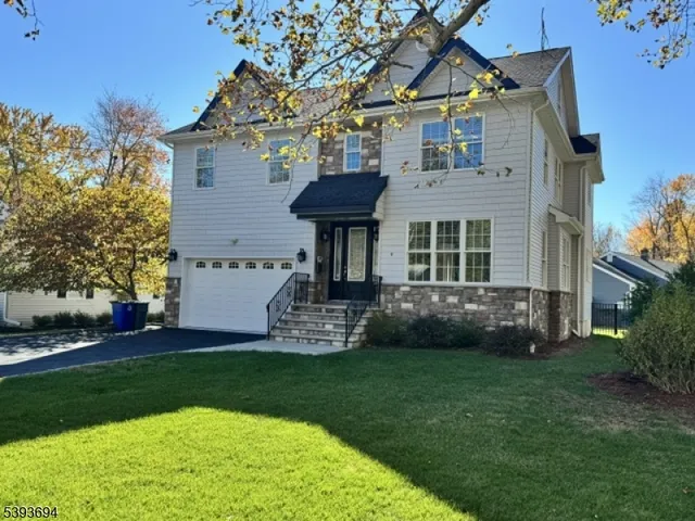 a front view of a house with a garden and plants