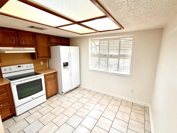 a view of a kitchen with a microwave and a stove