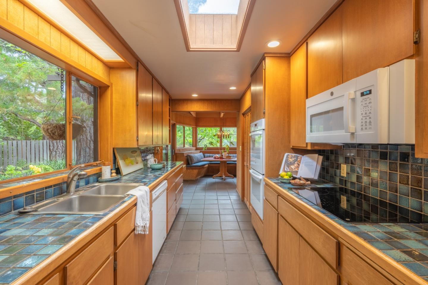 46 Middle Canyon Road Carmel Valley, CA 93924 - Photo 18 of 74 a kitchen with stainless steel appliances a sink window and cabinets