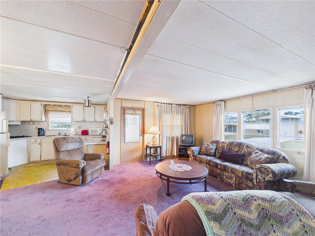 6135 98th Lane Sebastian, FL 32958 - Photo 12 of 18 a living room with furniture and a flat screen tv