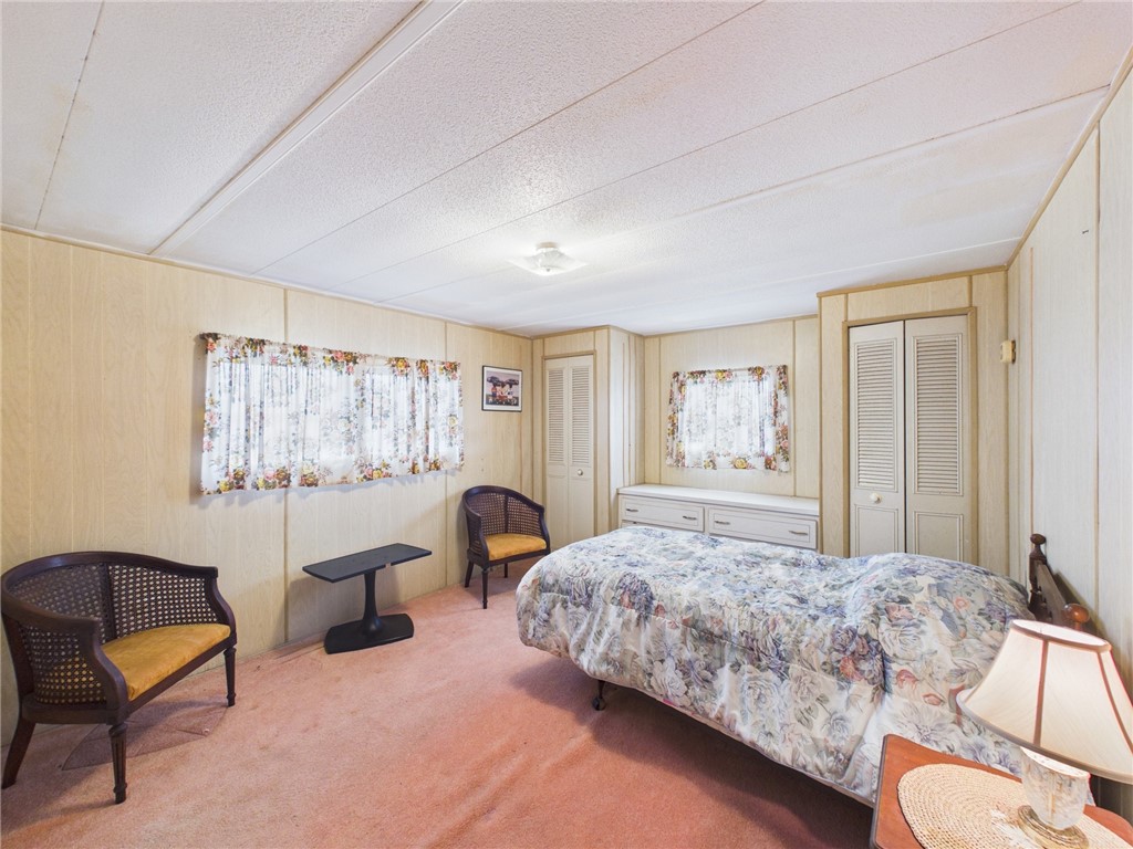 6135 98th Lane Sebastian, FL 32958 - Photo 13 of 18 a bedroom with a bed and a couch