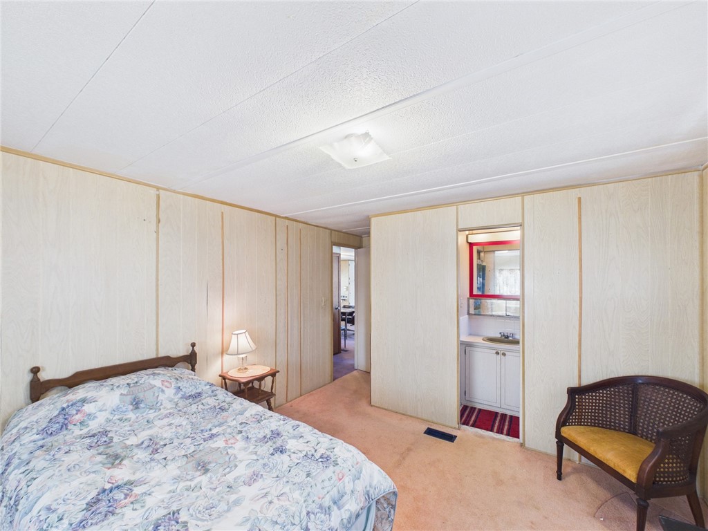 6135 98th Lane Sebastian, FL 32958 - Photo 14 of 18 a bedroom with a bed and a couch