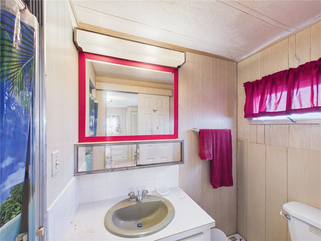 6135 98th Lane Sebastian, FL 32958 - Photo 15 of 18 a bathroom with a sink and a mirror