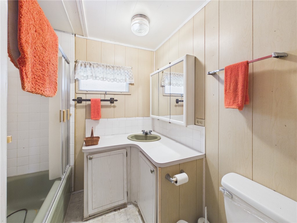 6135 98th Lane Sebastian, FL 32958 - Photo 18 of 18 a bathroom with a sink a toilet a mirror and shower