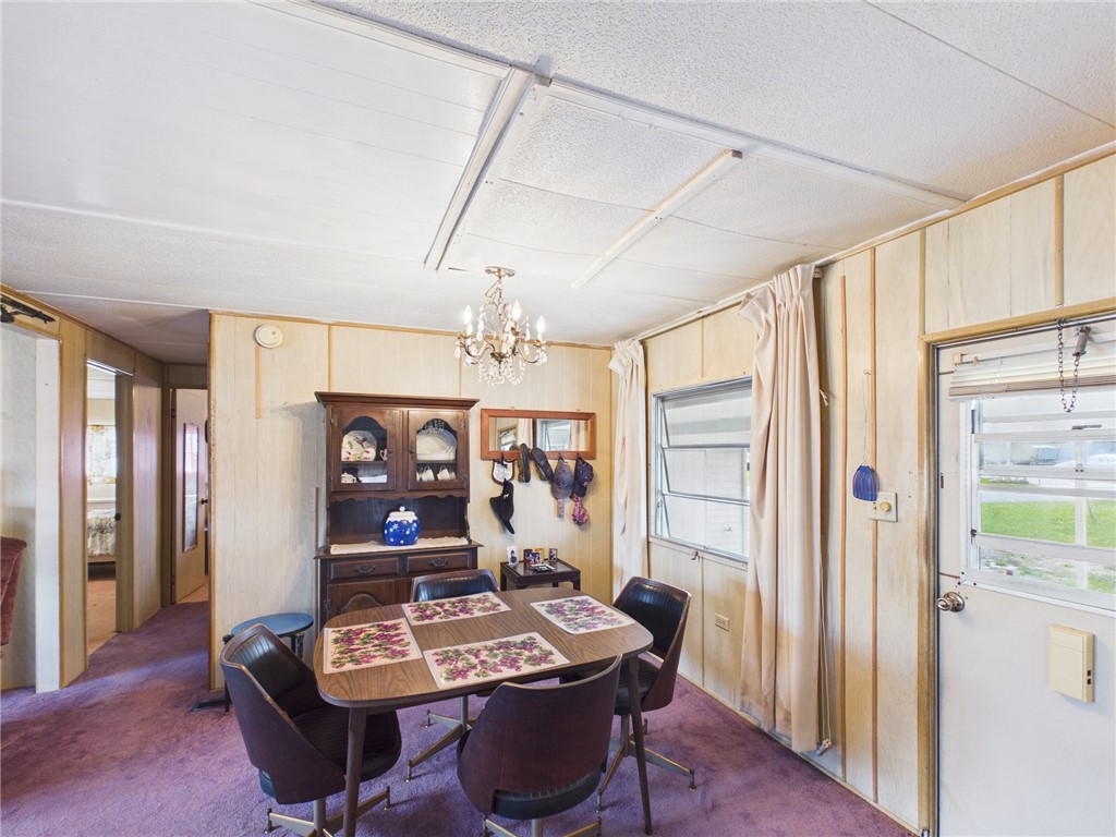 6135 98th Lane Sebastian, FL 32958 - Photo 4 of 18 a living room with furniture a flat screen tv and a window
