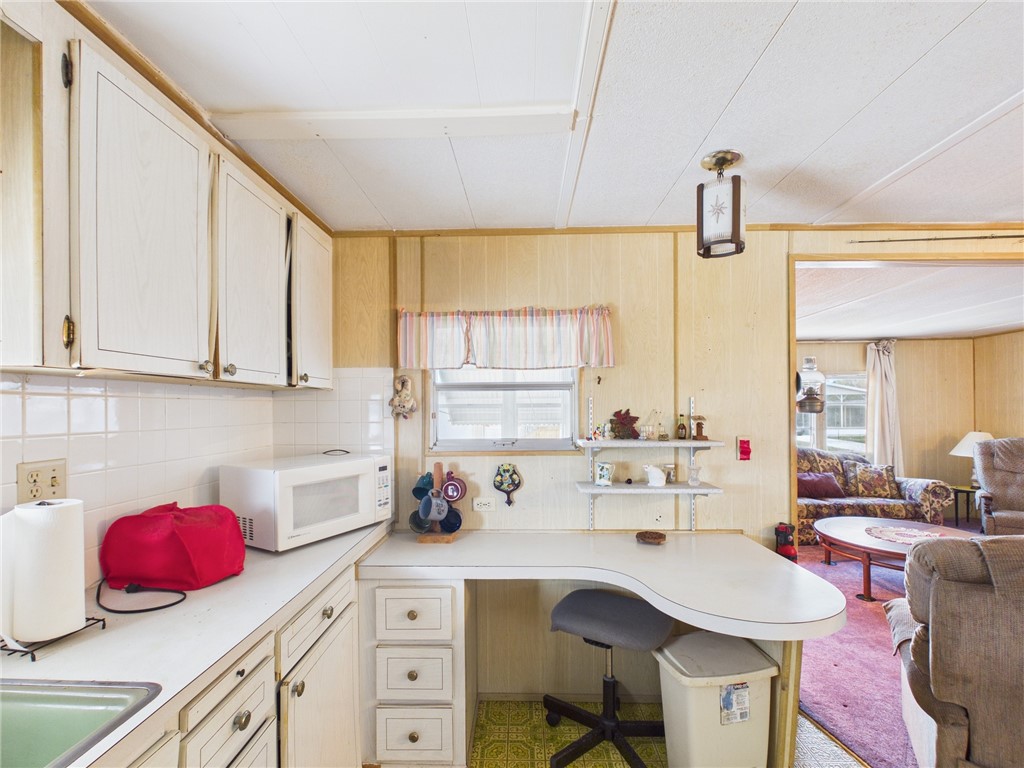 6135 98th Lane Sebastian, FL 32958 - Photo 8 of 18 a kitchen with a sink stove and cabinets