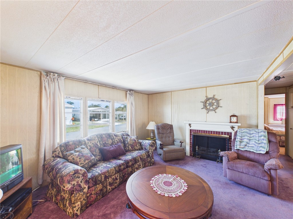 6135 98th Lane Sebastian, FL 32958 - Photo 10 of 18 a living room with furniture and a fireplace