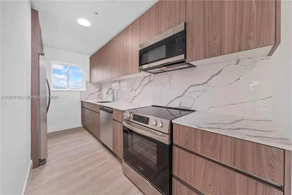 a kitchen with a stove microwave and refrigerator