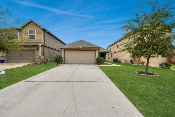 a front view of house with yard and green space