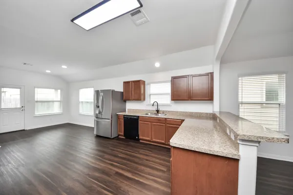 a kitchen with sink cabinets and wooden floor