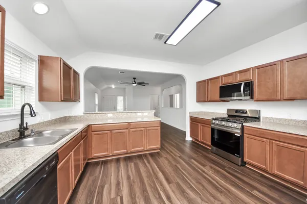 a kitchen with stainless steel appliances granite countertop a sink and stove top oven