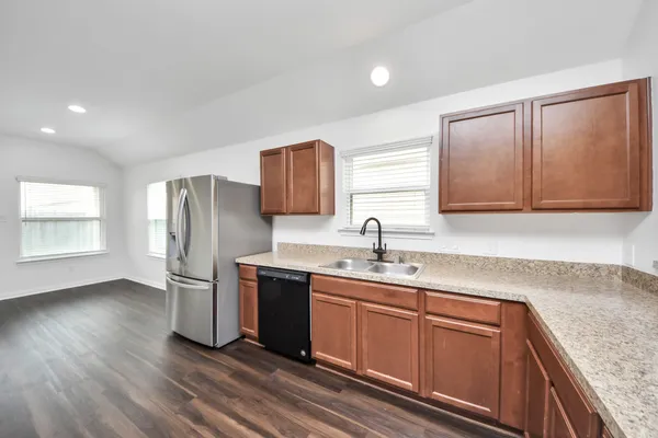 a kitchen with stainless steel appliances granite countertop a sink stove and refrigerator