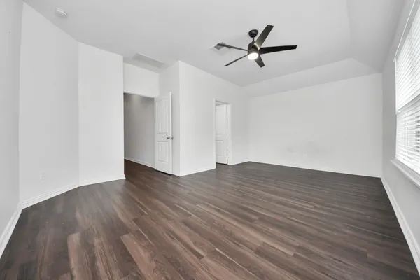 wooden floor in an empty room with a window
