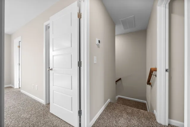 a view of a big room with windows and chandelier fan