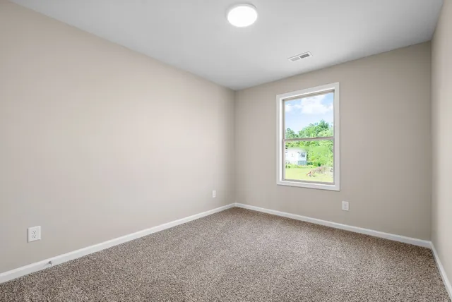 a view of an empty room and closet area