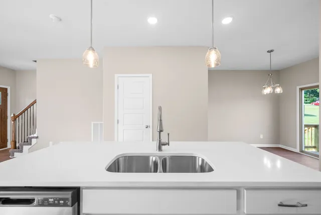 a kitchen with a sink a counter space and a window
