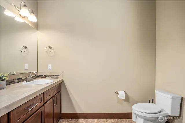 a bathroom with a sink a toilet and a mirror